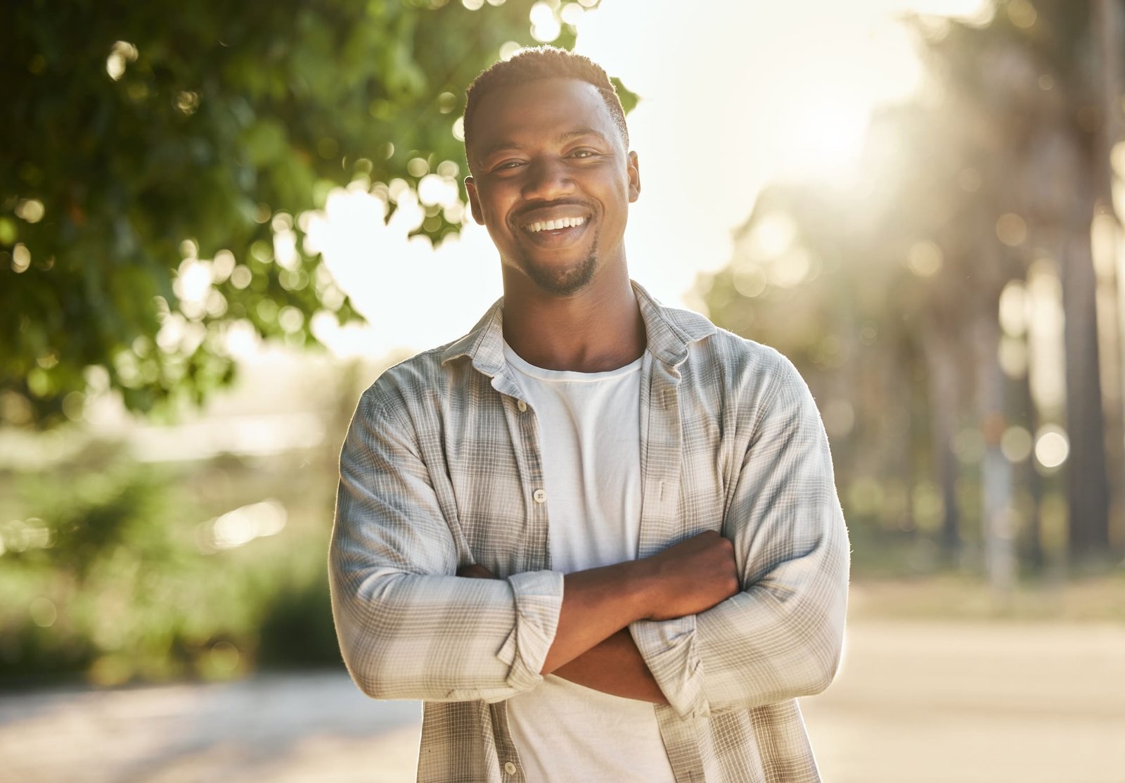 A smiling man, stands in the light, happy service with beacon of inner healing LLC